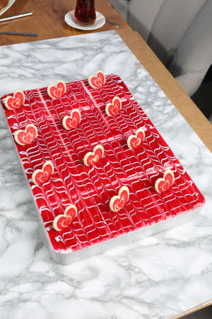 Board with delicious cake on tableの写真素材