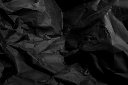 black creased crumpled paper background grunge texture backdropの写真素材