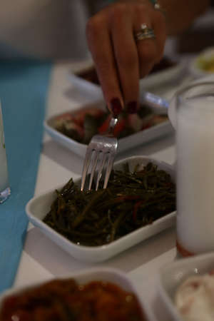 Turkish and Greek Traditional Dinning Table with Special Alcohol Drink Raki. Ouzo and Turkish Raki is a dry anise flavored aperitif that is widely consumed in Turkey, Greece, Cyprus and Lebanonの写真素材