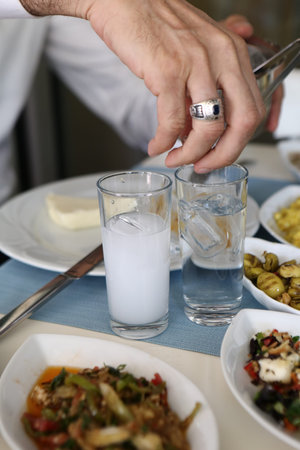 Turkish and Greek Traditional Dinning Table with Special Alcohol Drink Raki. Ouzo and Turkish Raki...