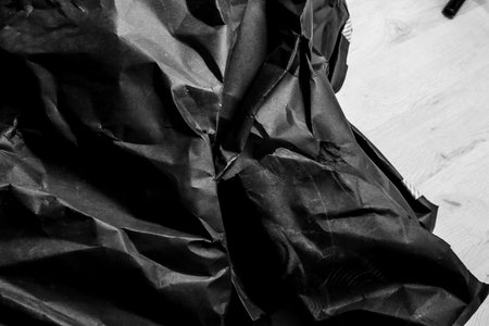 black creased crumpled paper background grunge texture backdrop
