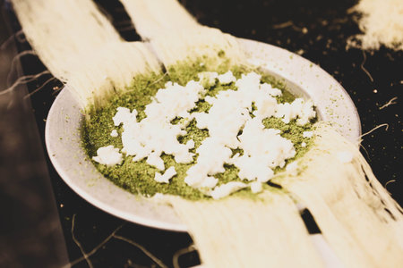 Turkish dessert kunefe, kunafa, kadayif with pistachio powder and cheese hot eaten a sweet