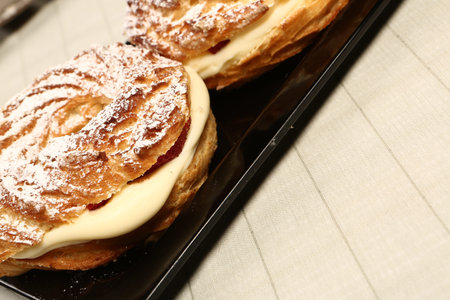 Board with delicious cake on table