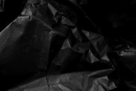 black creased crumpled paper background grunge texture backdropの写真素材