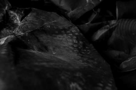 black creased crumpled paper background grunge texture backdropの写真素材