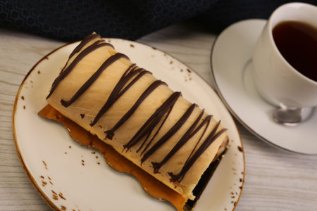 Board with delicious cake on table