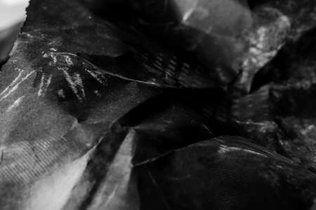 black creased crumpled paper background grunge texture backdropの写真素材