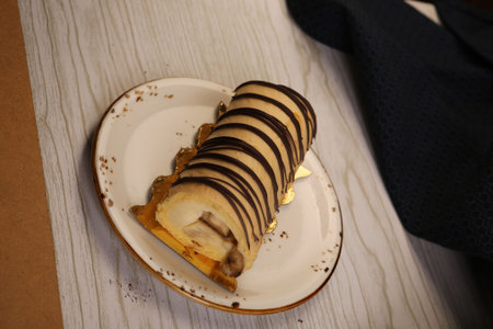 Board with delicious cake on table