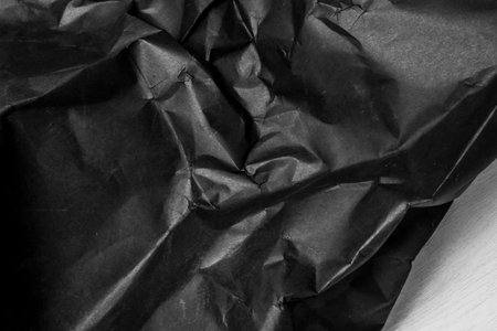 black creased crumpled paper background grunge texture backdropの写真素材