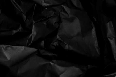 black creased crumpled paper background grunge texture backdropの写真素材