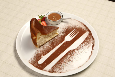 Board with delicious cake on tableの写真素材