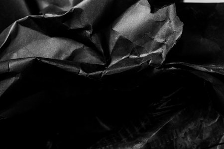black creased crumpled paper background grunge texture backdropの写真素材