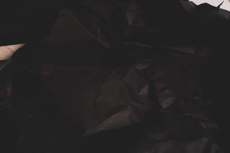 black creased crumpled paper background grunge texture backdropの写真素材