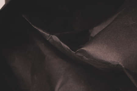 black creased crumpled paper background grunge texture backdropの写真素材