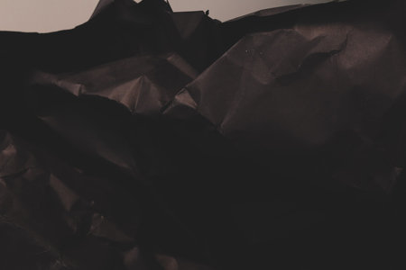 black creased crumpled paper background grunge texture backdropの写真素材