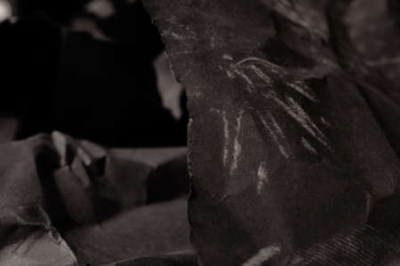 black creased crumpled paper background grunge texture backdropの写真素材