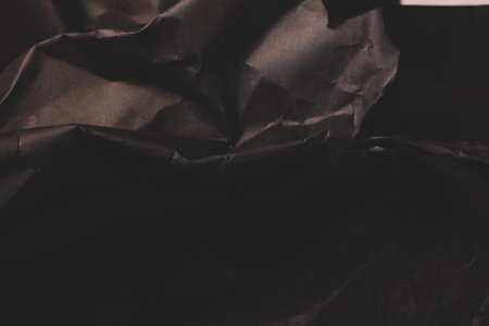 black creased crumpled paper background grunge texture backdropの写真素材