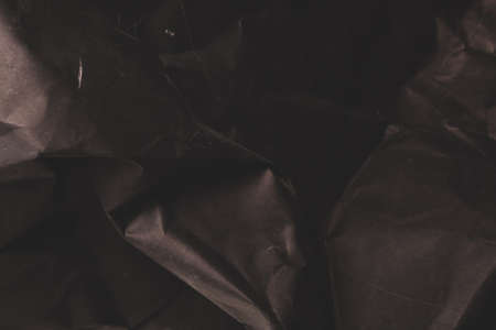 black creased crumpled paper background grunge texture backdropの写真素材