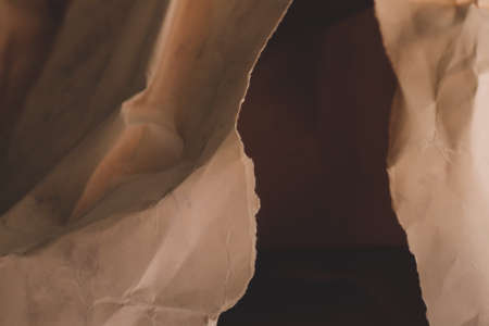 orange creased crumpled paper background grunge texture backdropの写真素材