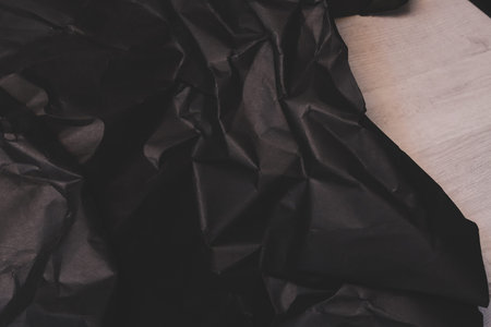 black creased crumpled paper background grunge texture backdropの写真素材
