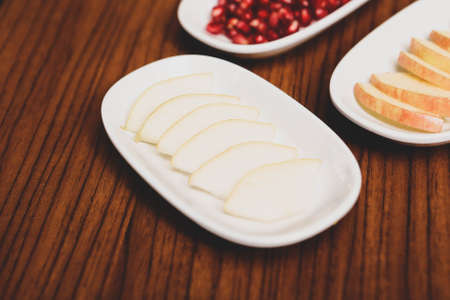 Plate with delicious mixed fruits and sliced fruitsの写真素材