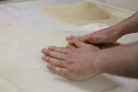 Making a turkish pizza or lahmacun - fast food and popular street food in Mediterranean countries.