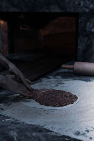 Making a turkish pizza or lahmacun - fast food and popular street food in Mediterranean countries.の写真素材