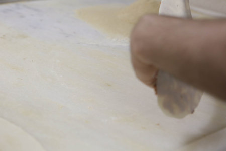 Making a turkish pizza or lahmacun - fast food and popular street food in Mediterranean countries.