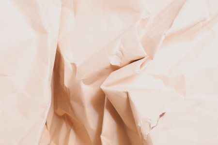 orange creased crumpled paper background grunge texture backdropの写真素材