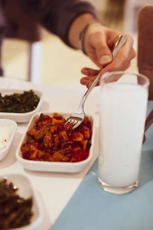 Turkish and Greek Traditional Dinning Table with Special Alcohol Drink Raki. Ouzo and Turkish Raki is a dry anise flavored aperitif that is widely consumed in Turkey, Greece, Cyprus and Lebanonの写真素材