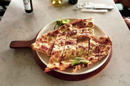 Traditional turkish baked dish pide. Turkish pizza pide, Middle eastern appetizers. Turkish cuisine. Pita with meat fillingの写真素材