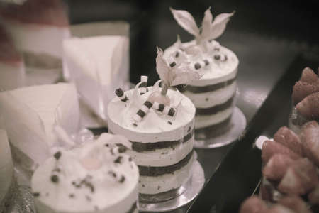 Board with delicious cake on tableの写真素材