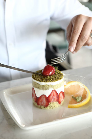 Board with delicious cake on table