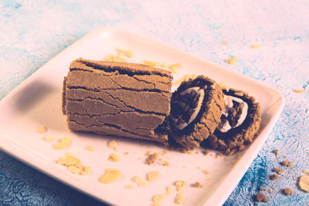 Board with delicious cake on tableの写真素材