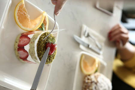 Board with delicious cake on tableの写真素材