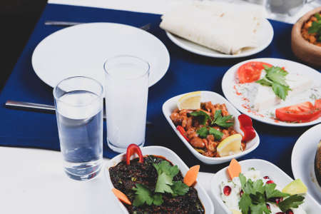 Turkish and Greek Traditional Dinning Table with Special Alcohol Drink Raki. Ouzo and Turkish Raki is a dry anise flavored aperitif that is widely consumed in Turkey, Greece, Cyprus and Lebanonの写真素材