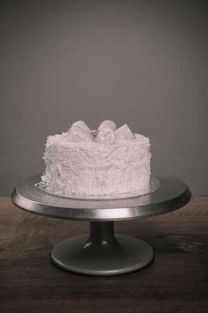 Board with delicious cake on tableの写真素材