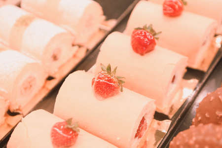 Board with delicious cake on tableの写真素材