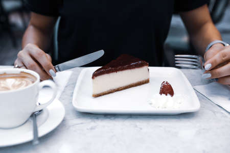 Board with delicious cake on tableの写真素材