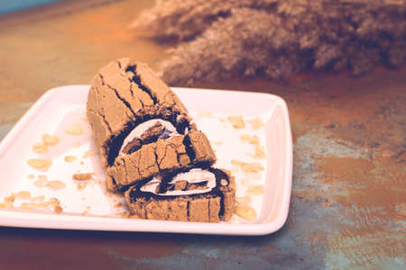 Board with delicious cake on tableの写真素材