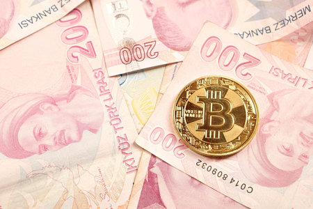 Turkish lira banknotes and bitcoin coin