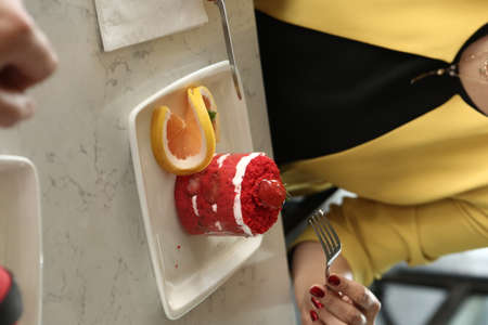 Board with delicious cake on tableの写真素材