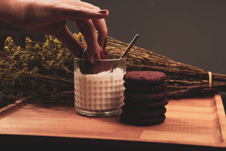 Dipping delicious cookies in a glass of milk