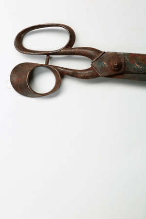 Rusty and old scissors on white backgroundの写真素材
