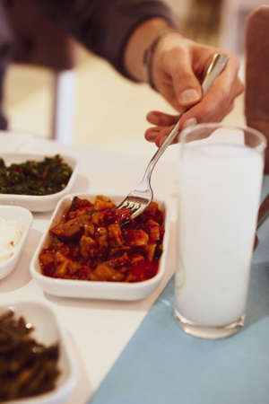 Turkish and Greek Traditional Dinning Table with Special Alcohol Drink Raki. Ouzo and Turkish Raki is a dry anise flavored aperitif that is widely consumed in Turkey, Greece, Cyprus and Lebanonの写真素材