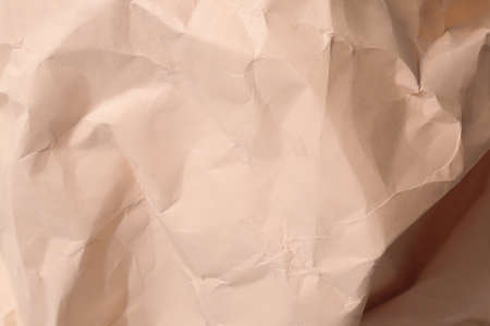 orange creased crumpled paper background grunge texture backdropの写真素材