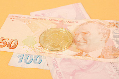 Turkish lira banknotes and bitcoin coin
