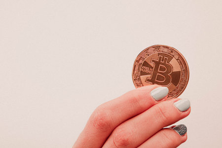 A young girl holds dollars cash and bitcoin with her hands, Different type of new generation...