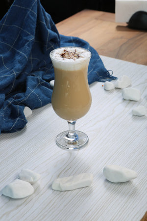 Iced coffee with milk. Iced coffee latte. Woman holding glass cup of iced coffee.