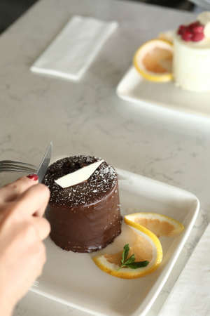 Board with delicious cake on tableの写真素材